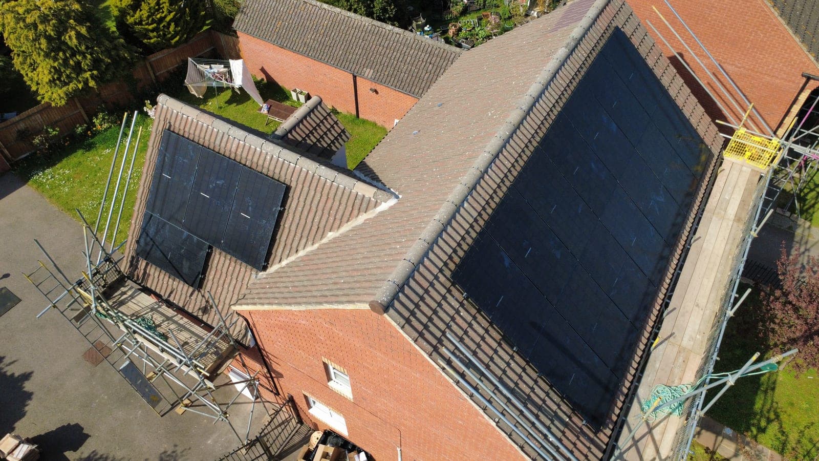 Drone aerial view of Nikki Martin's 14-panel rooftop solar array on a brick Midlands home