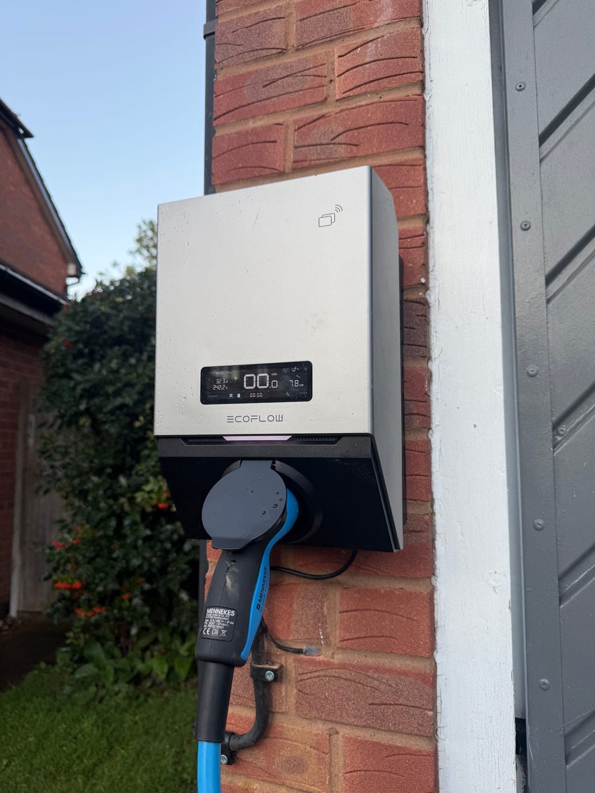 Home EV charger installed on a brick wall