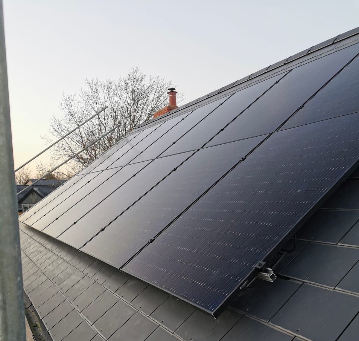Solar panels on a slate roof at golden hour