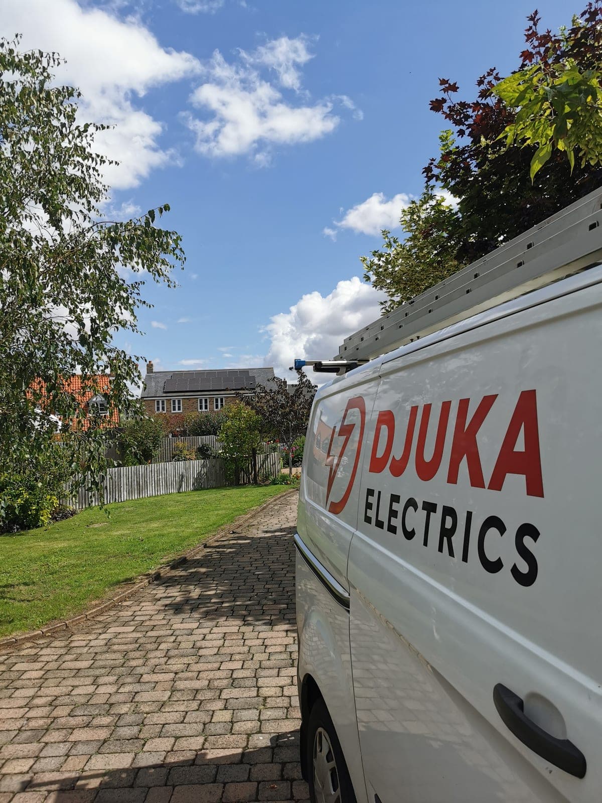 Djuka Electrics van in a customer's driveway